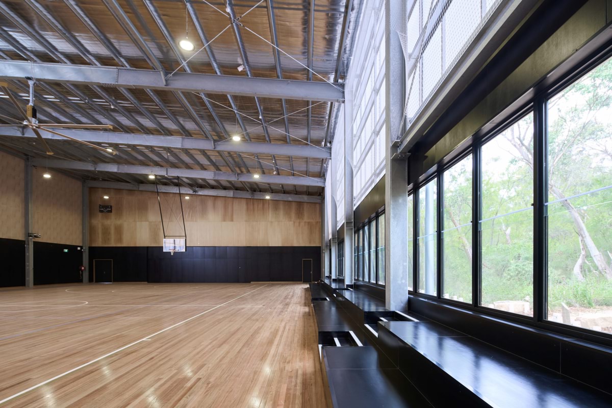 Photo of gymnasium floor, seating and windows