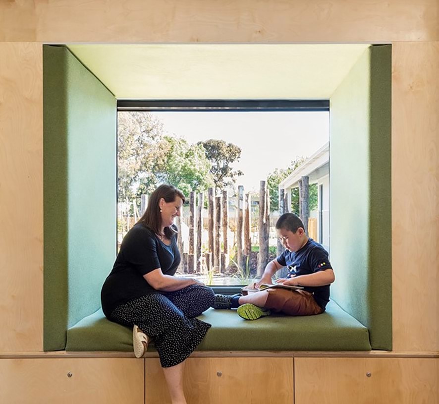 Photo of student reading by the window