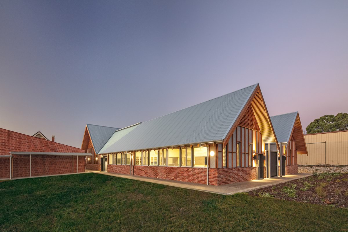 Photo of the school building with lights on