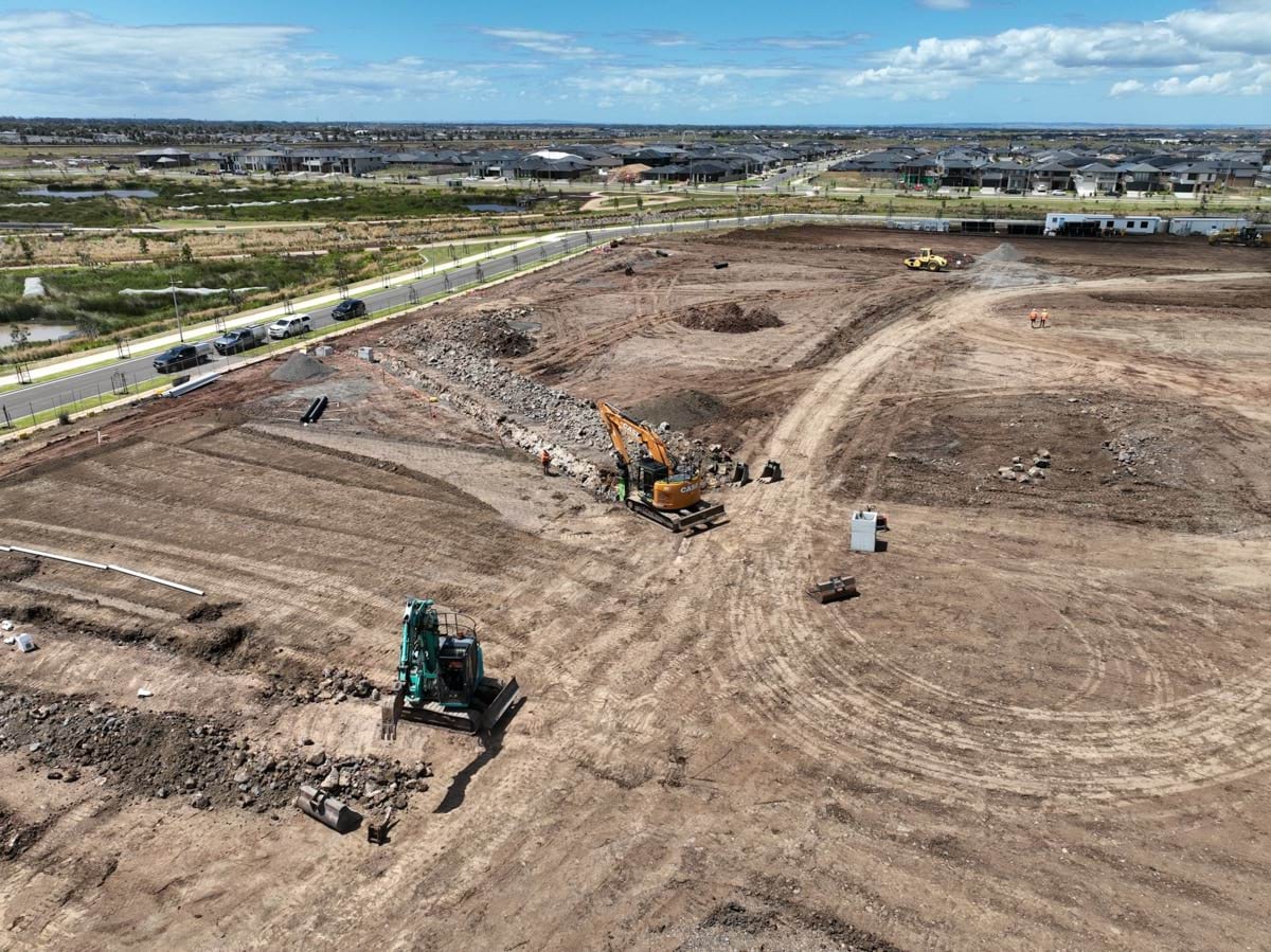 Black Forest East Primary School (interim name) - construction site progress in January 2023 - aerial shot of site showing flattened earth and 2 cranes. 