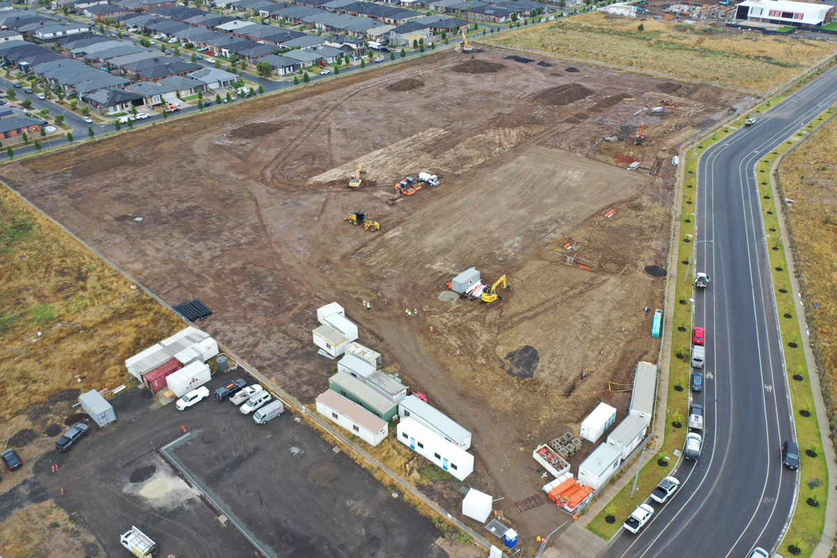 Merrifield South Primary School (interim name) - construction photo of site progress in January 2023 - aerial shot of site showing portables, flattened earth and surrounding roads