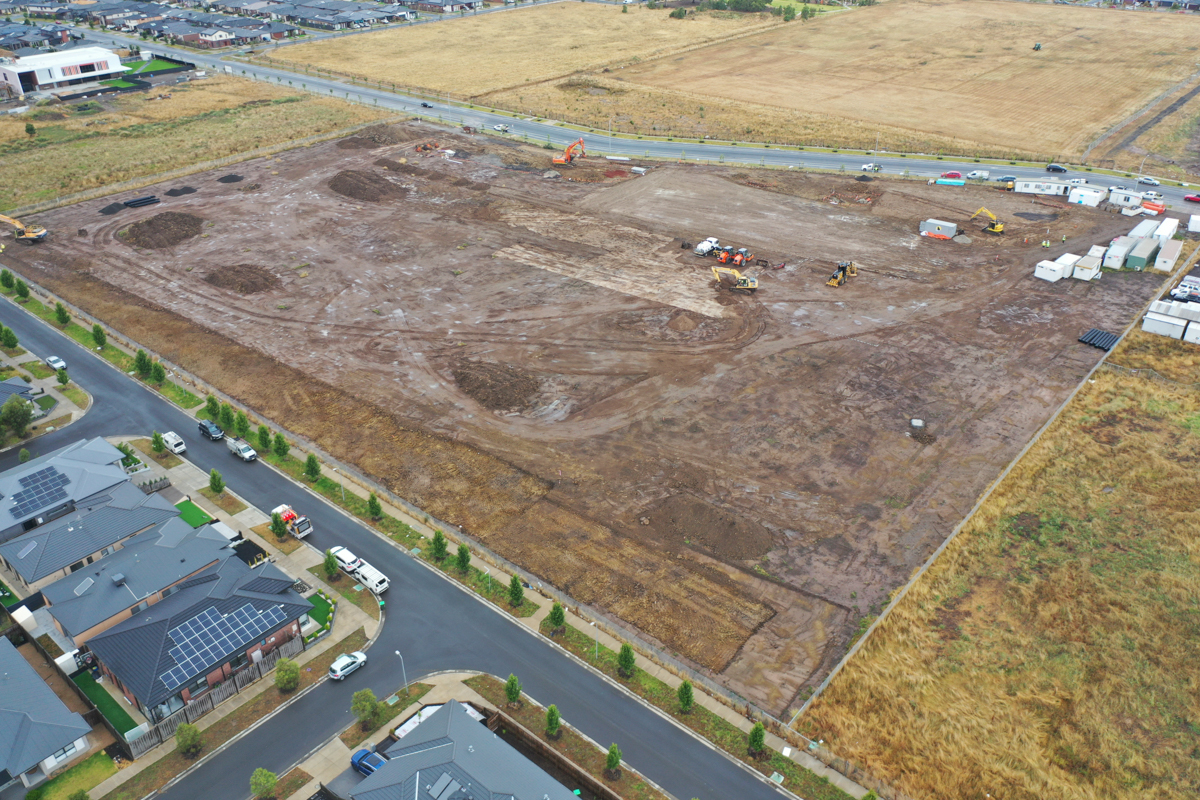 Merrifield South Primary School (interim name) - construction photo of site progress in January 2023 - aerial shot of site showing portables, flattened earth and surrounding roads