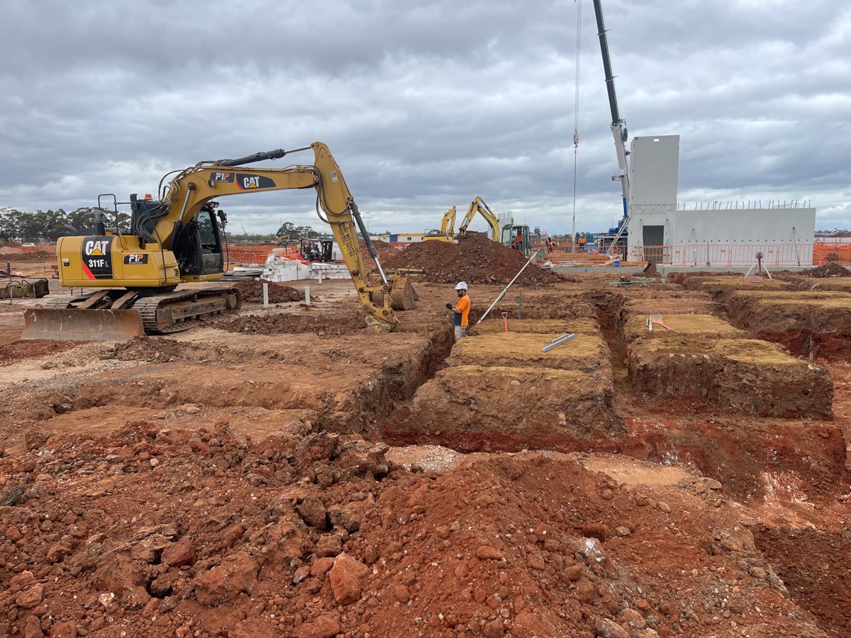 Aintree Secondary School (interim name) - construction photo of site progress in March 2023 - a mechanical digger creating foundations