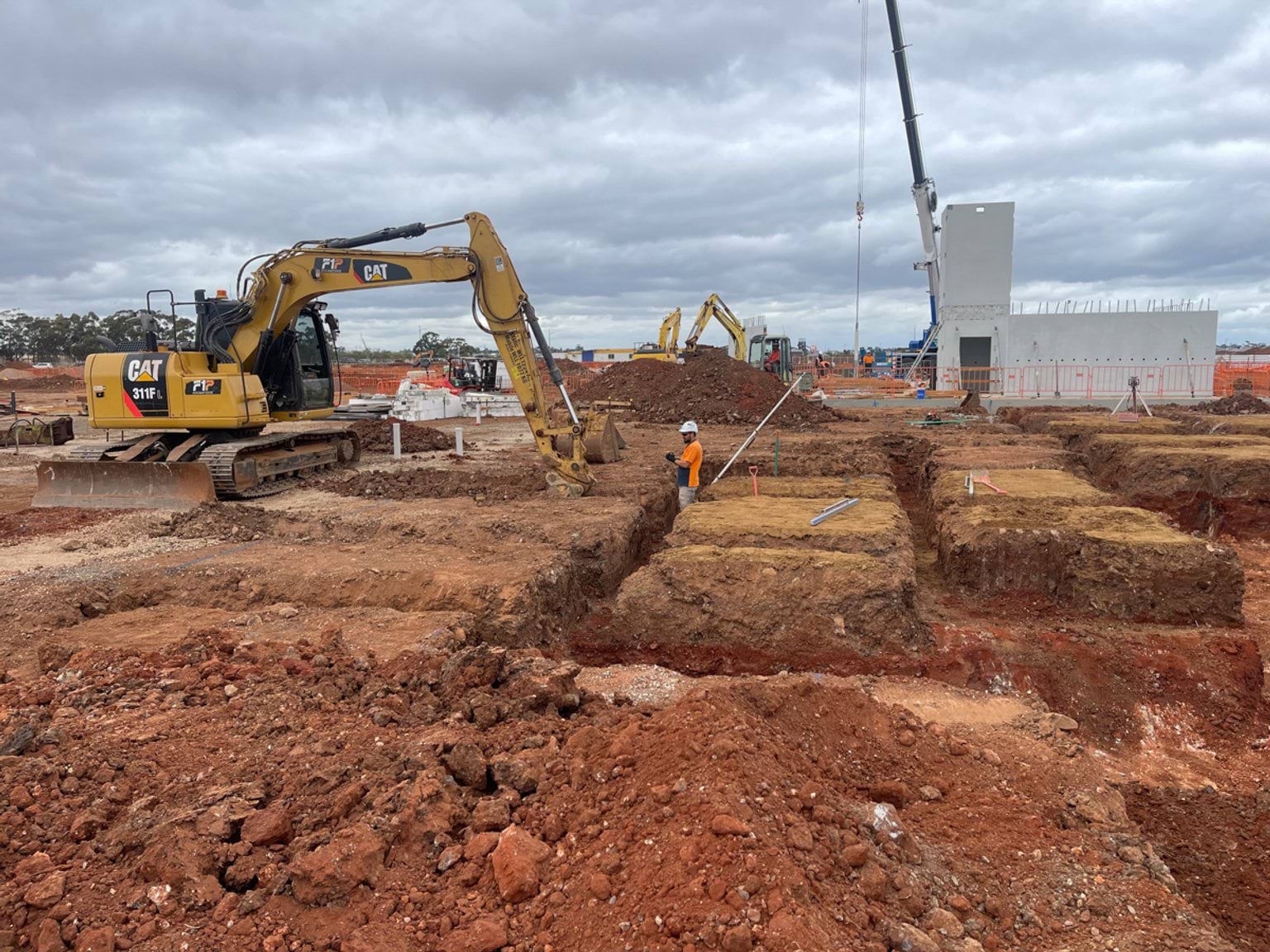 Aintree Secondary School (interim name) - construction photo of site progress in March 2023 - a mechanical digger creating foundations