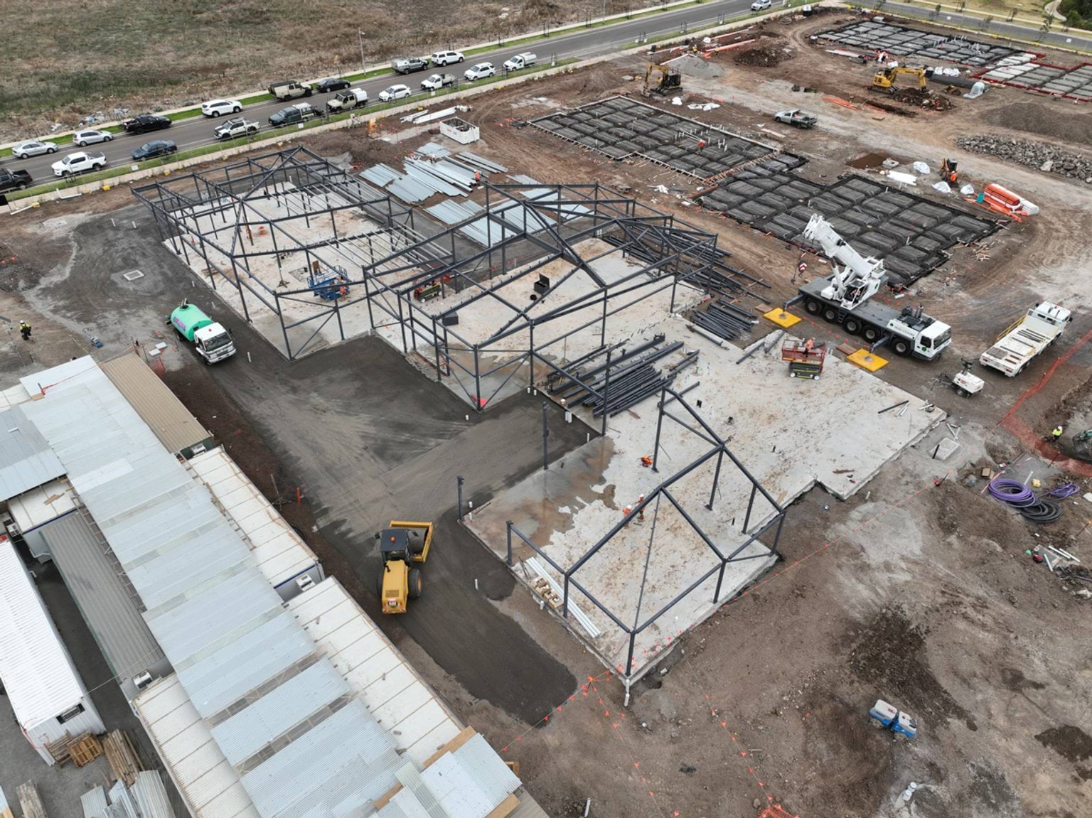 Black Forest East Primary School (interim name) - construction site progress in March 2023 - aerial shot of site showing steel frameworks of school buildings