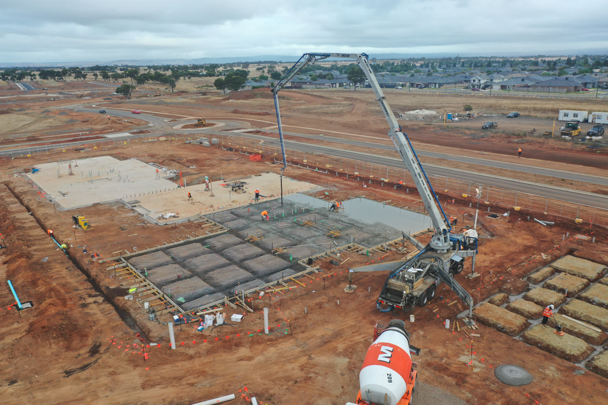 Brookfield Primary School (interim name) - construction photo of site progress in March 2023 showing a crane and a concrete mixer