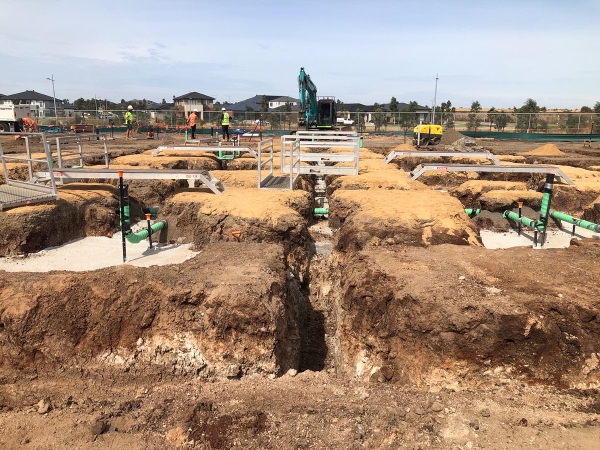 Lollypop Creek Secondary School (interim name) - construction photo of site progress in February 2023 showing foundations and pipework
