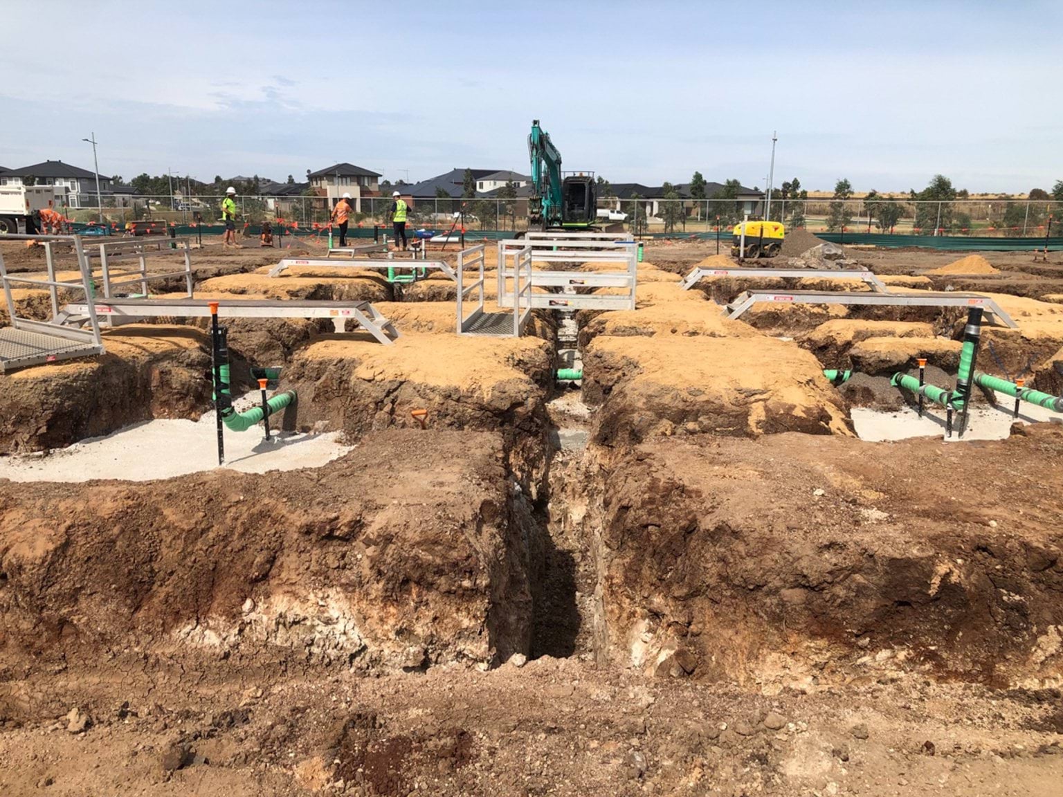 Lollypop Creek Secondary School (interim name) - construction photo of site progress in February 2023 showing foundations and pipework