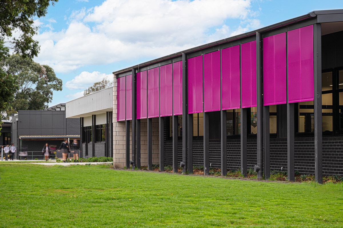 Lyndale Secondary College - photo of a grey and purple school building surrounded by grass 