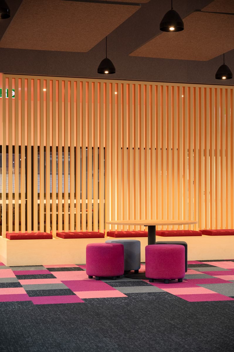 Lyndale Secondary College - interior photo of a school building with light wood panelling and soft bright cushions