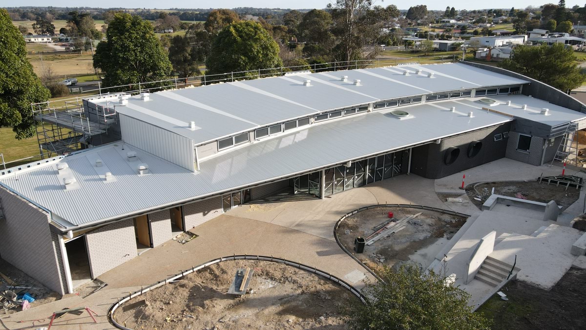 This is an aerial image of the Orbost Community College construction site. It shows the exterior of a school building with the roof in place.