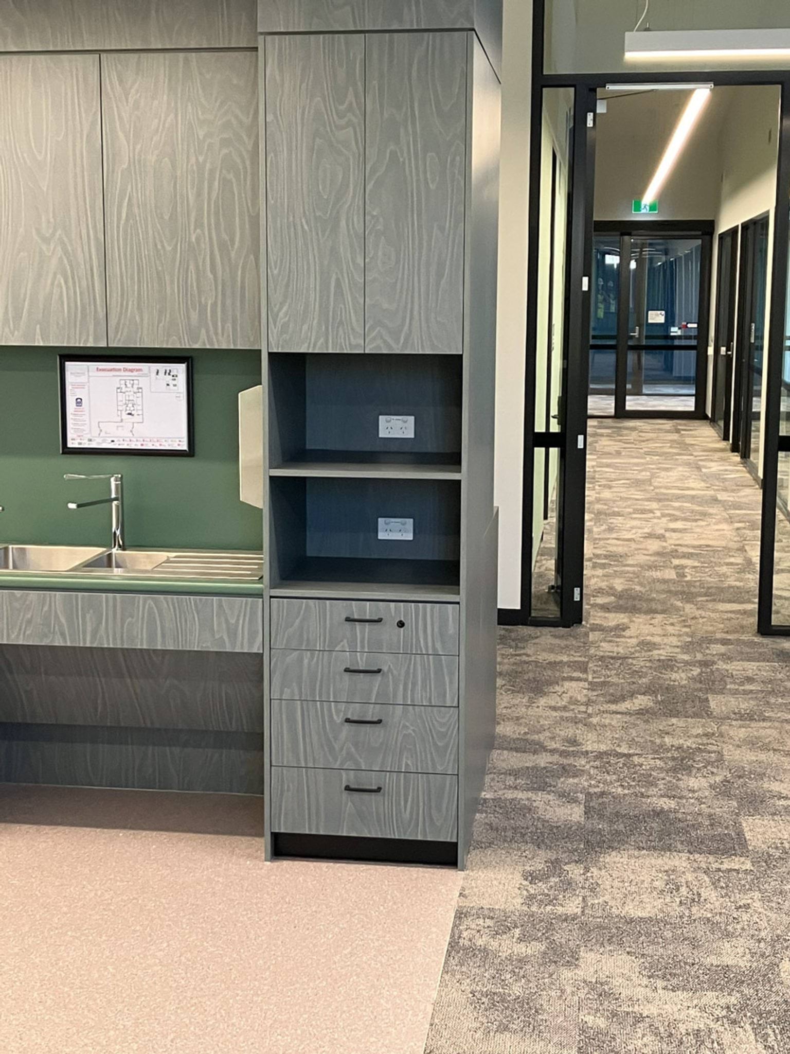 Kitchenette with new cabinetry and carpeting 