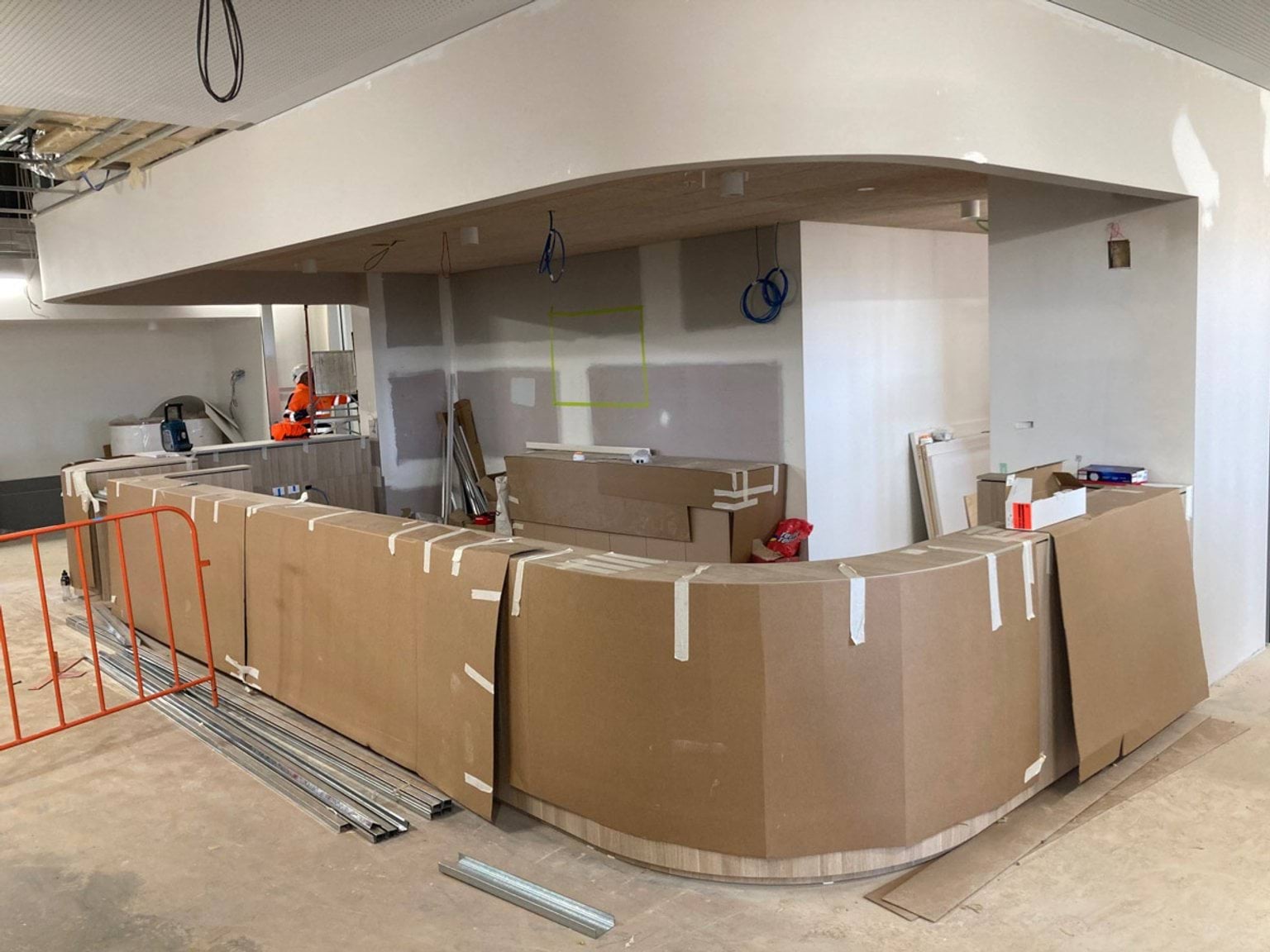 Rounded bench of main reception that has cardboard still protecting it