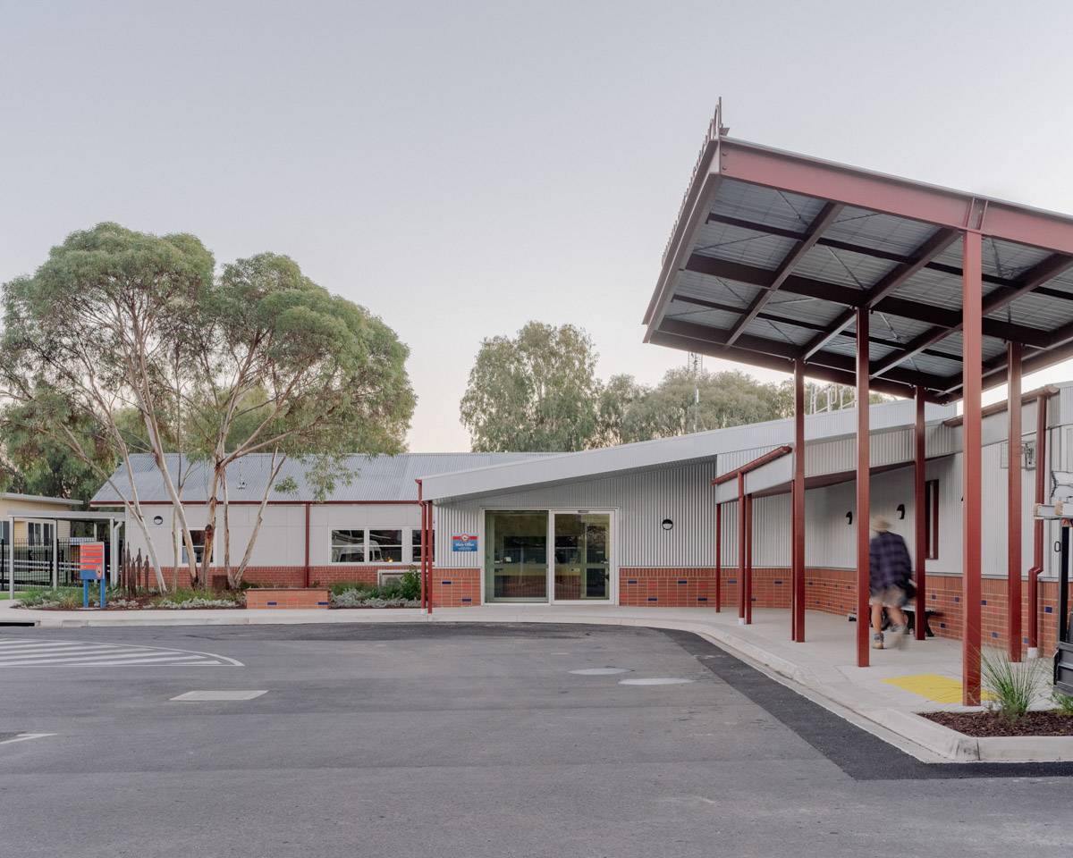 The entrance of Swan Hill Specialist School, looking from the road drop-off area. The school building is single-storey with a covered roof area over part of the road. 