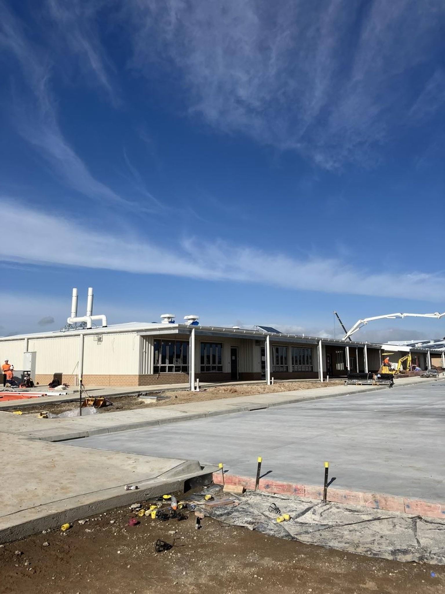 Freshly laid concrete slab in front of Birranga College buildings.