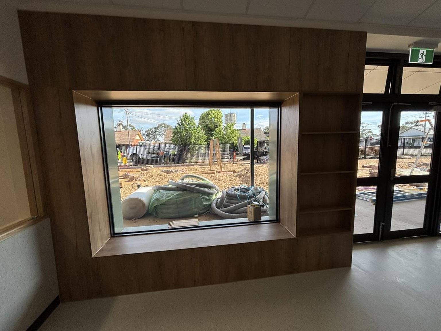 Inside the new Early Learning Victoria Numurkah (interim name) building, facing a large window that has a view to outside. 