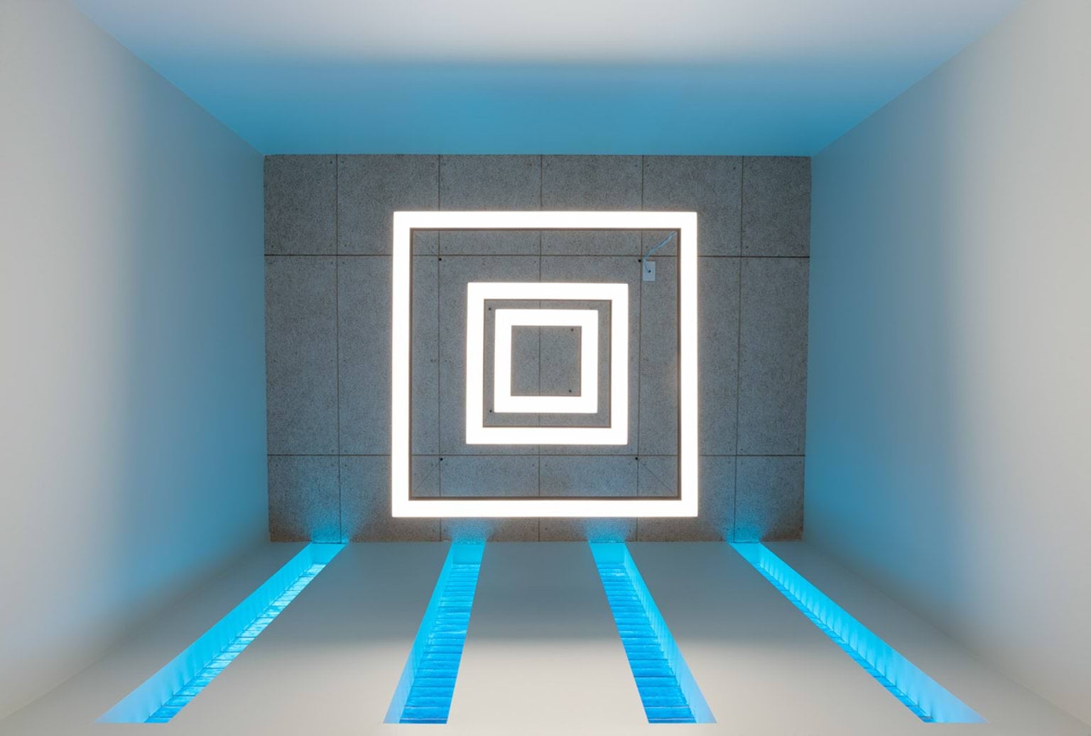 A modern ceiling design with square LED light frames arranged concentrically and blue accent lighting on the walls and floor panels.