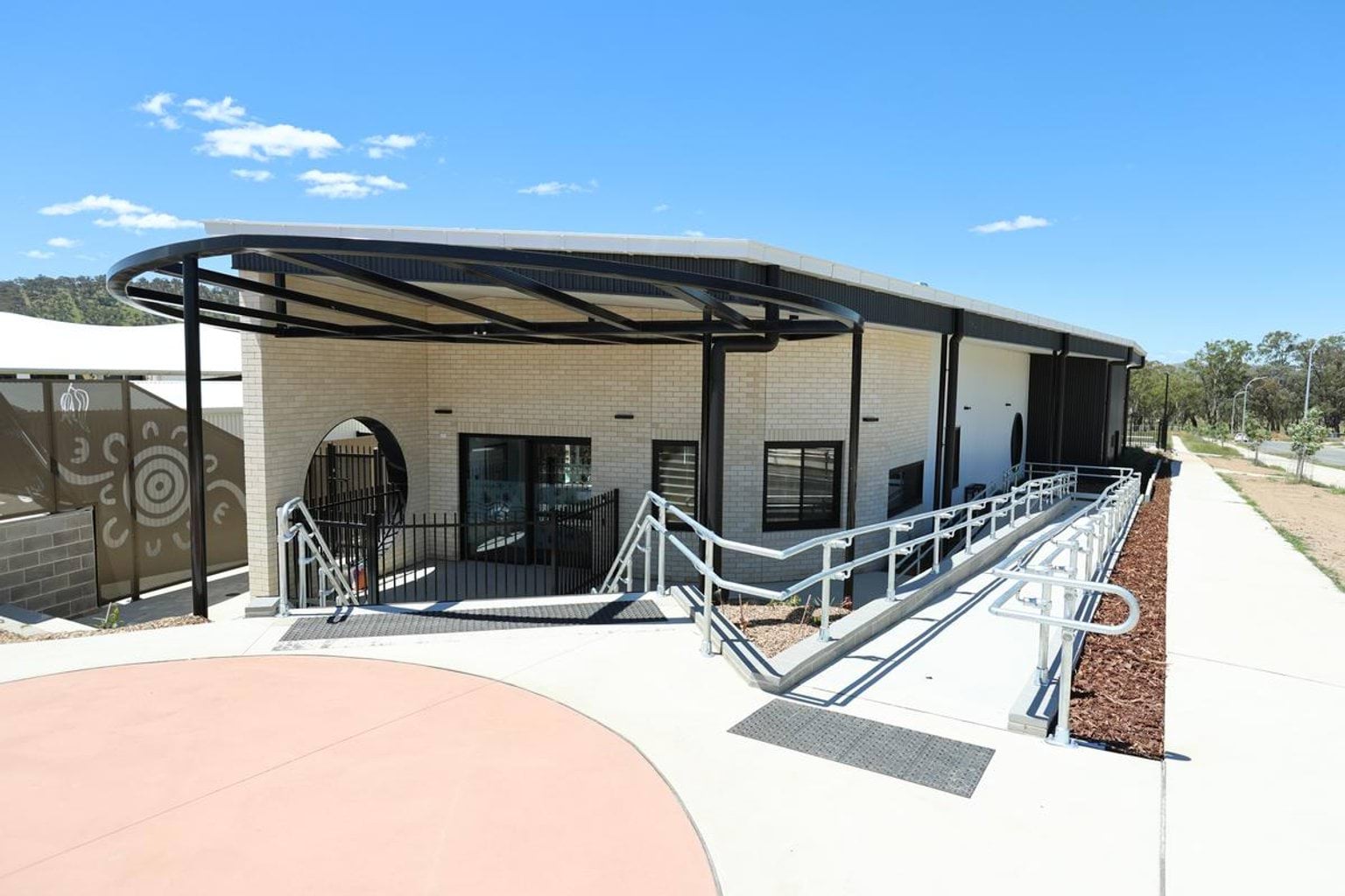Outside Kerribana Primary School Kindergarten (interim name), looking at a building with a ramp leading down to it.