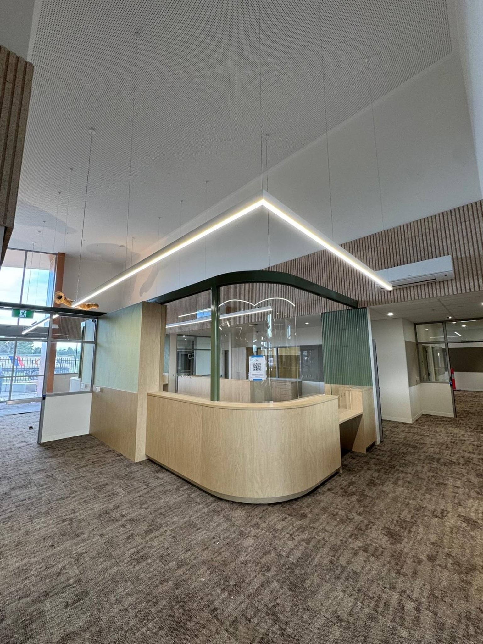 Photo of reception area. There is a doorway from outside that leads to a reception desk.