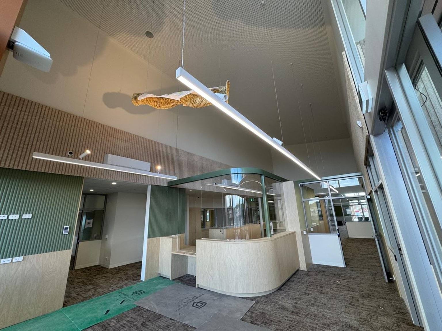 Photo of reception area. There is a hall with a door next to a reception desk.