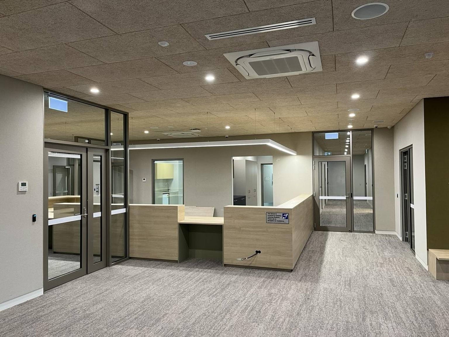 Reception area. There is a main desk and doors to each side.