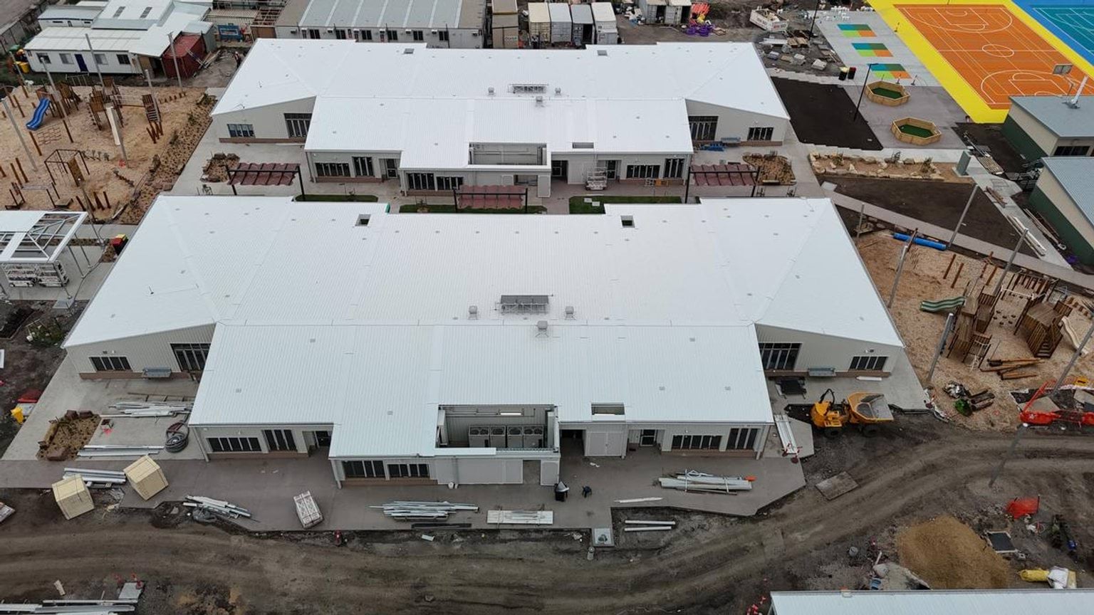 Overhead photo of school buildings with sports courts in background