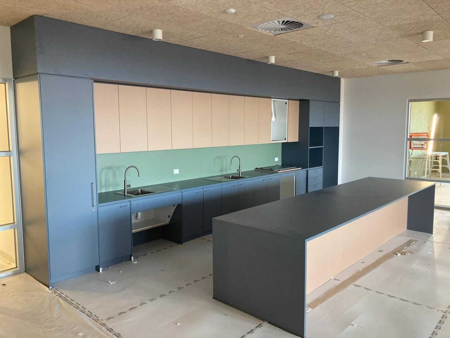 School room with bench, taps, sinks, and cupboards