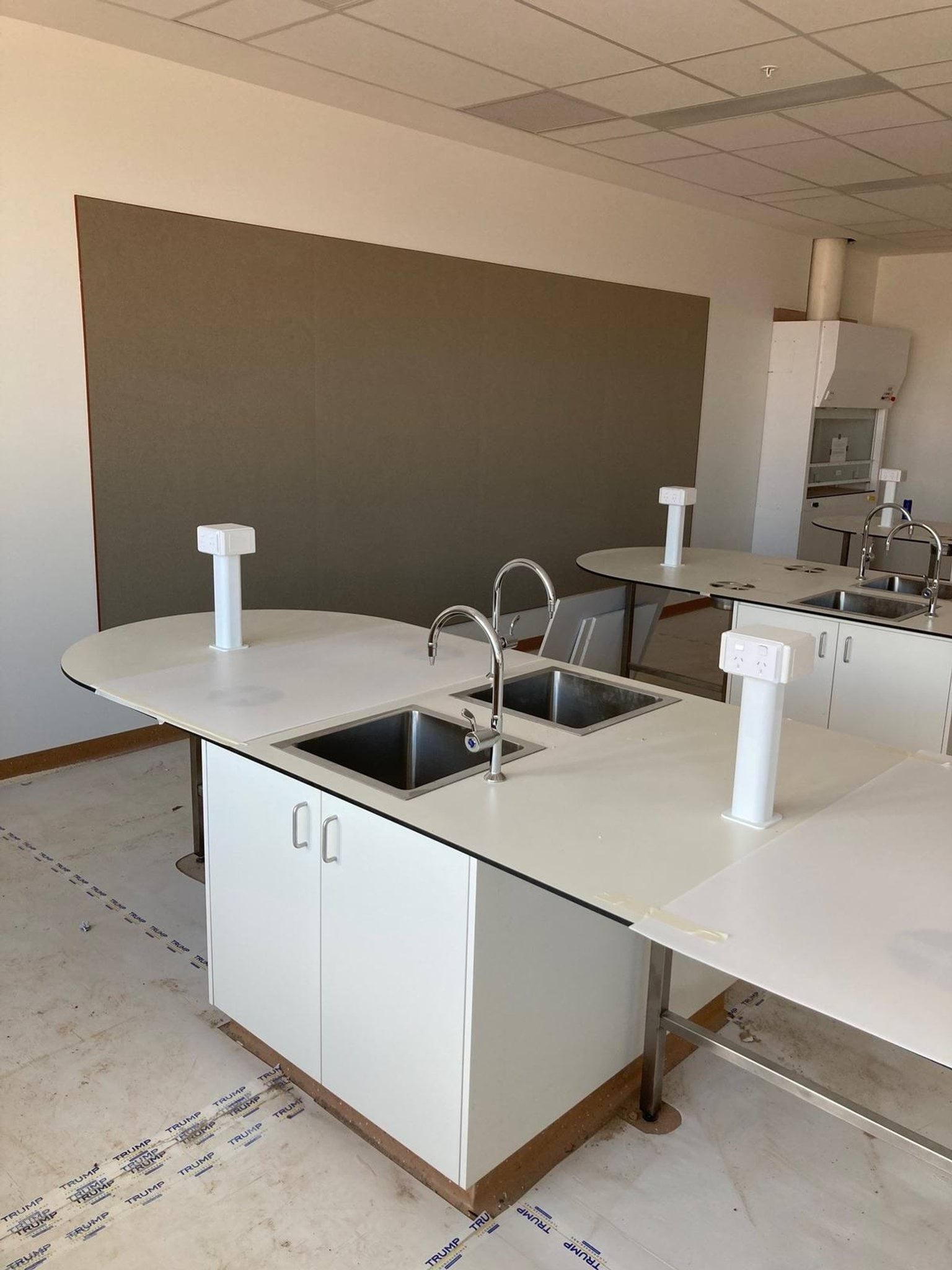 Science room with sinks on tables and board at front of room