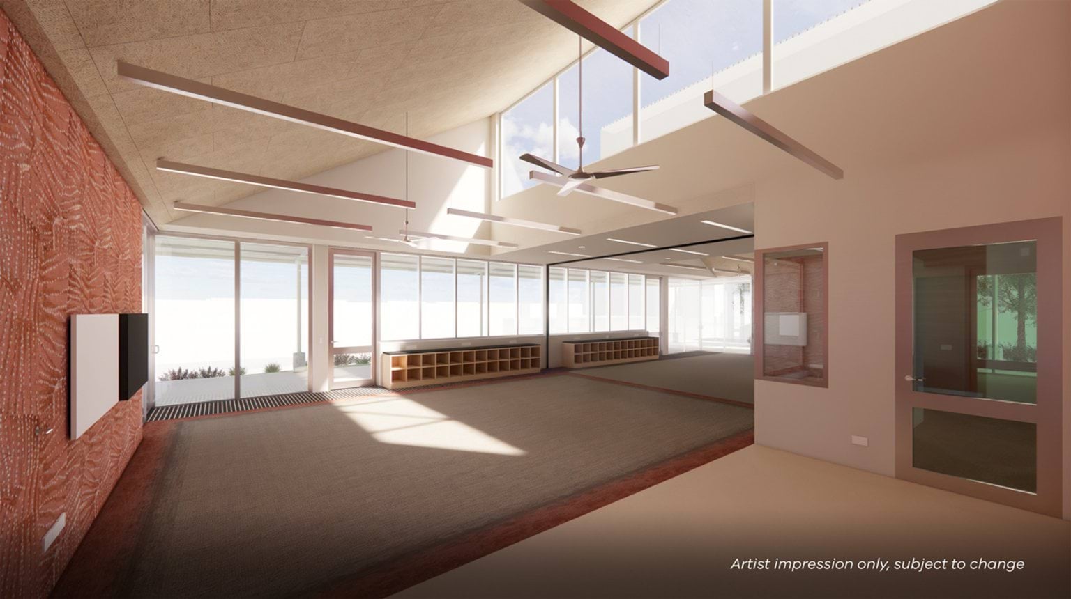 A bright learning space with high ceilings, skylights, and large windows, featuring built‑in storage and open floor areas.