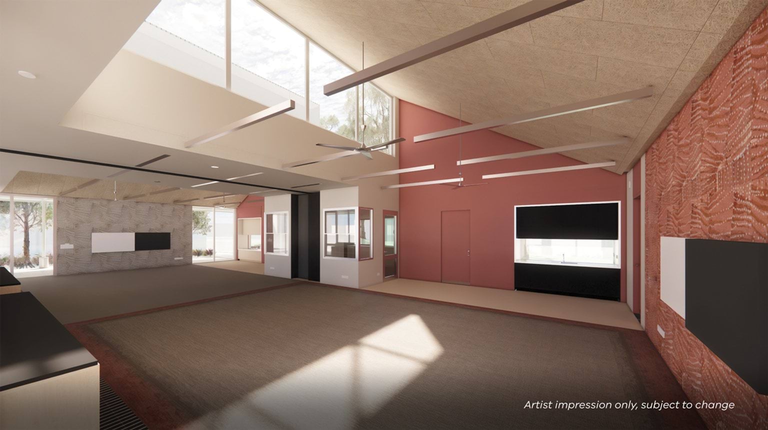 A spacious classroom with high ceilings, feature walls, ceiling fans, and large windows providing natural light.