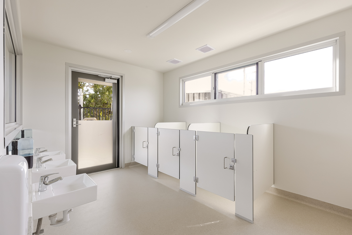 Child‑friendly bathroom with low sinks, toilet cubicles and accessible fixtures.