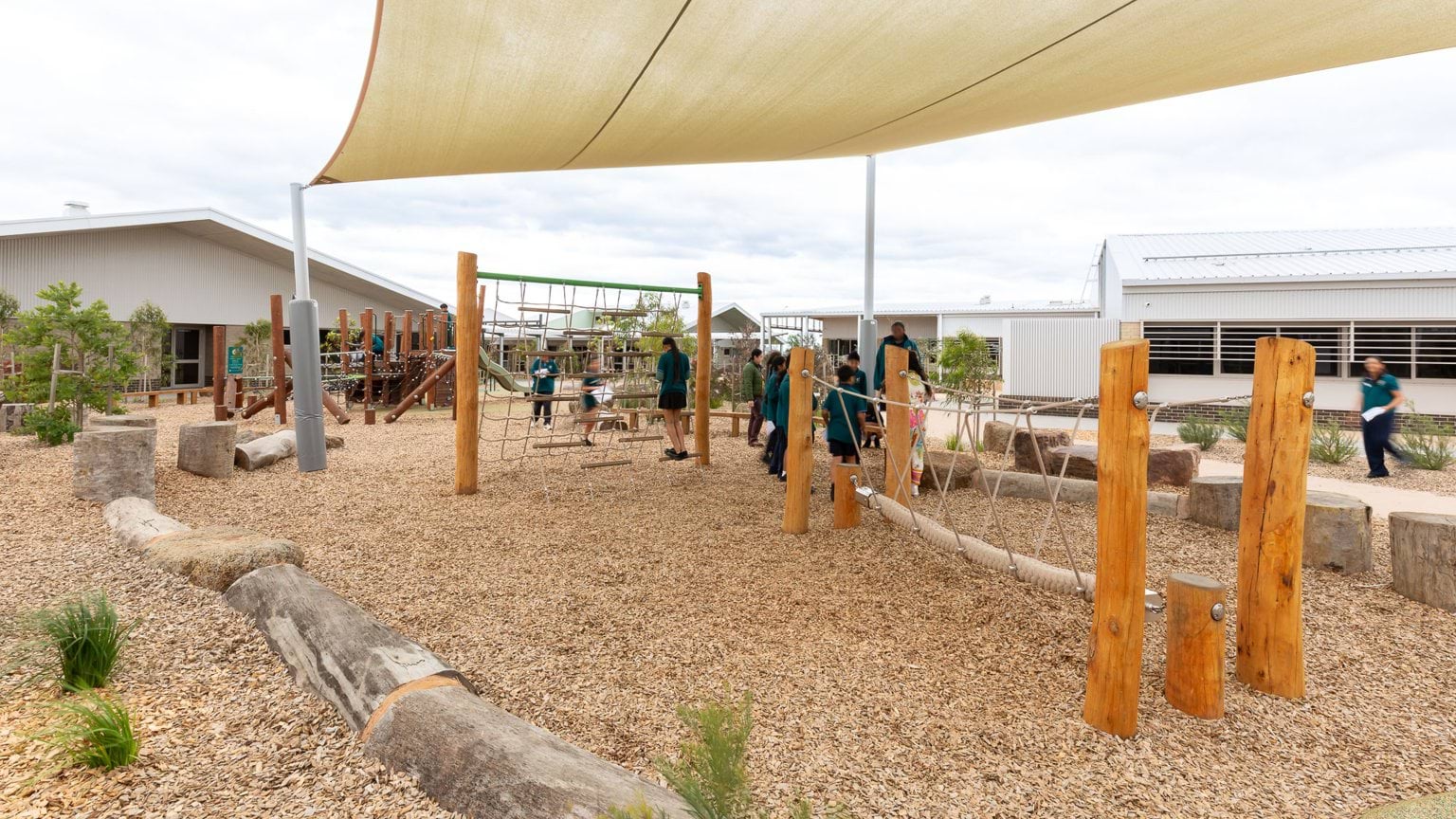 Students playing in covered outdoor playground area