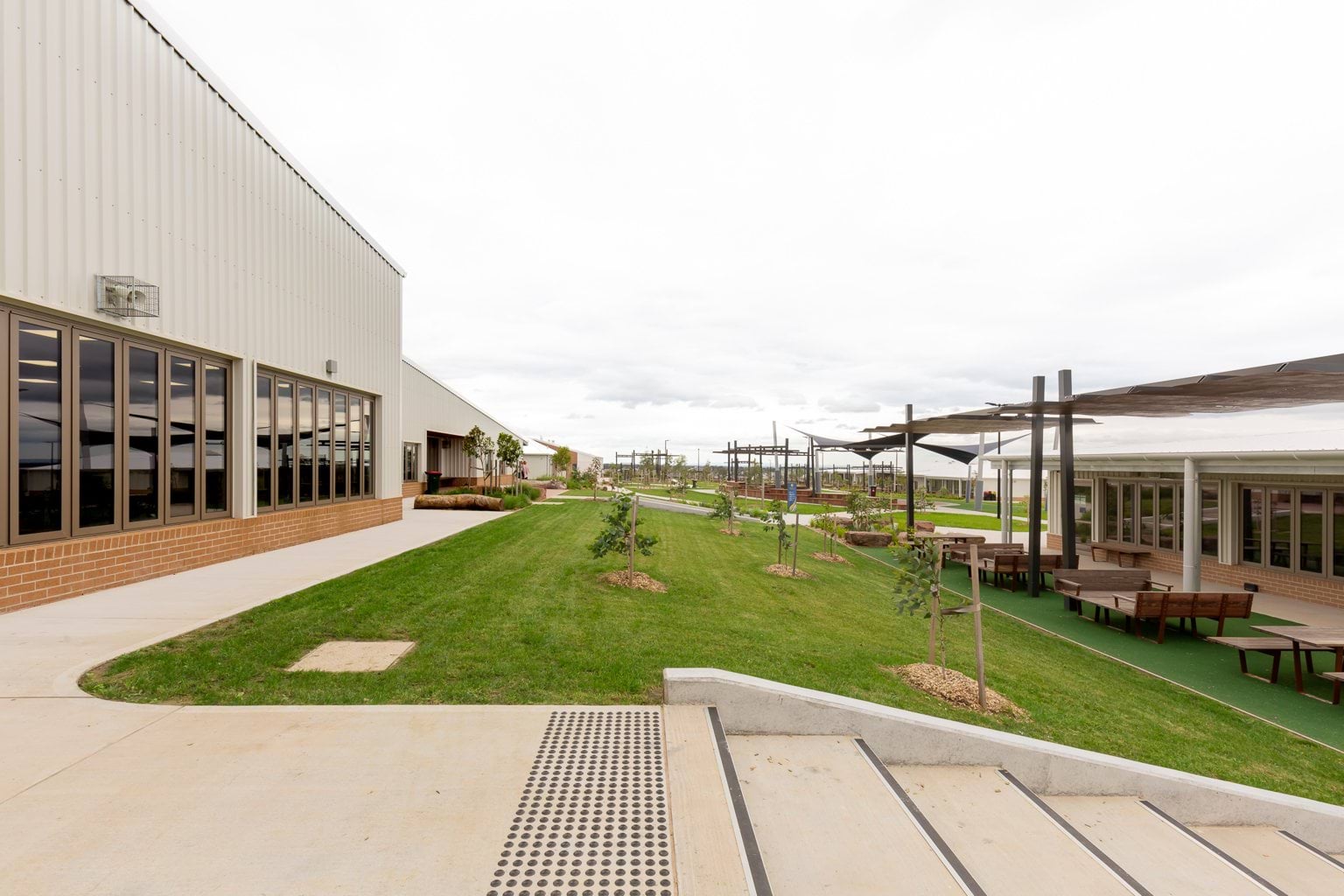 Grass area outside with covered seating and steps
