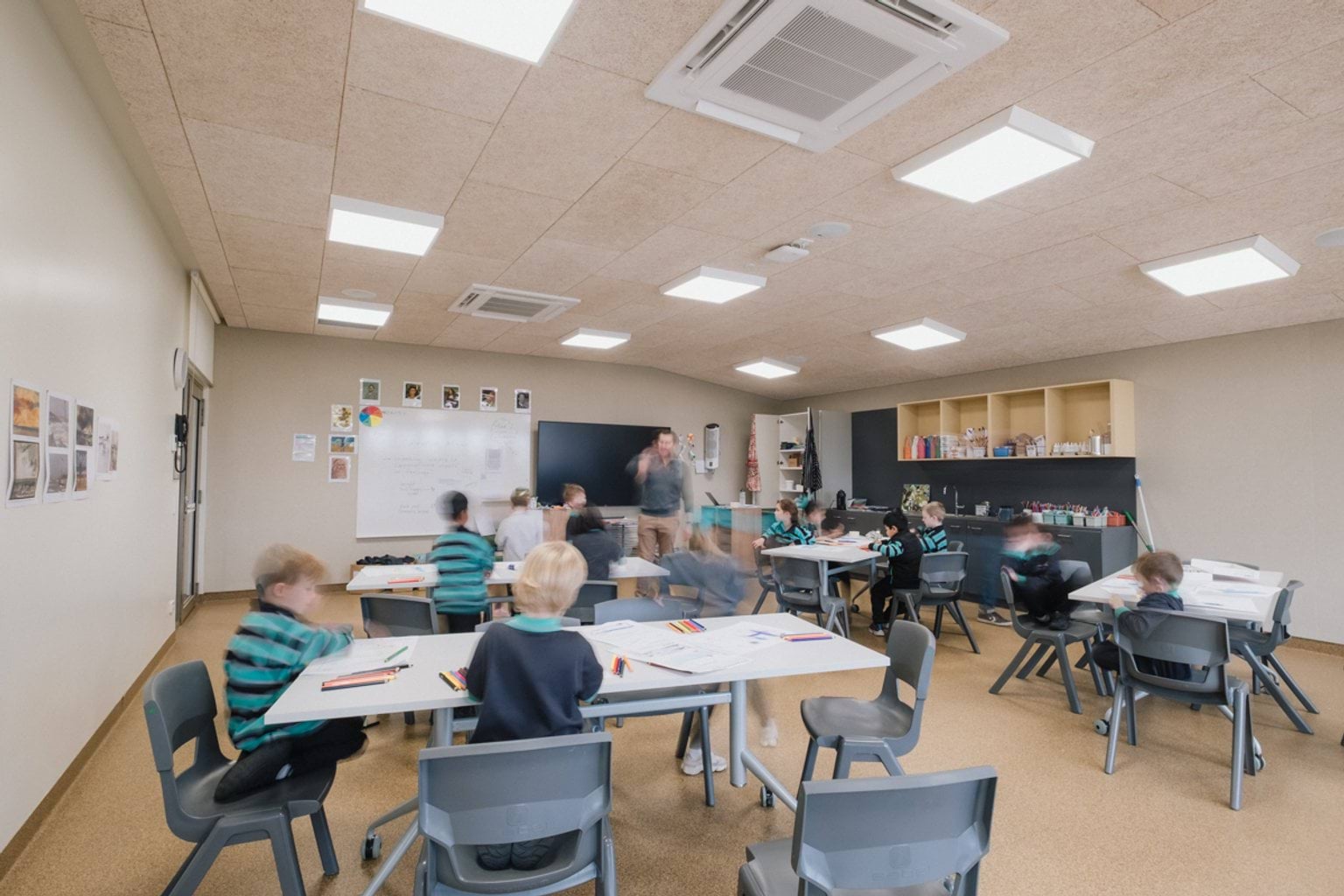 Students seated around tables in classroom