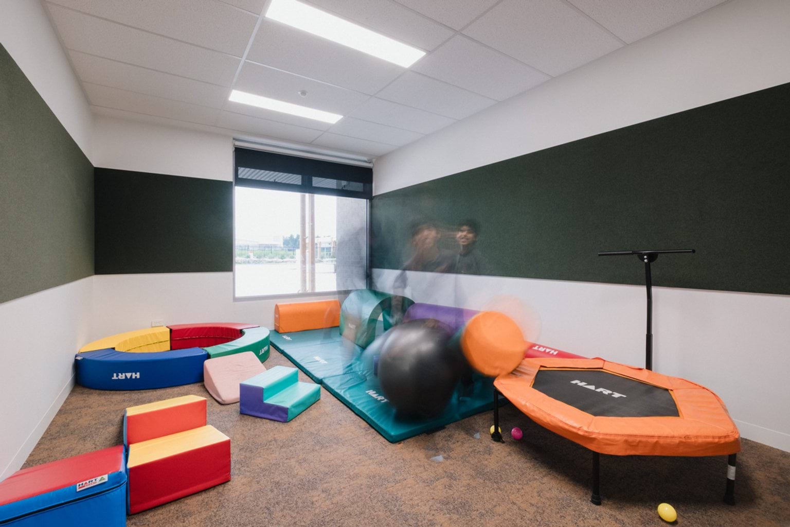 Soft play room with small trampoline and gym mats